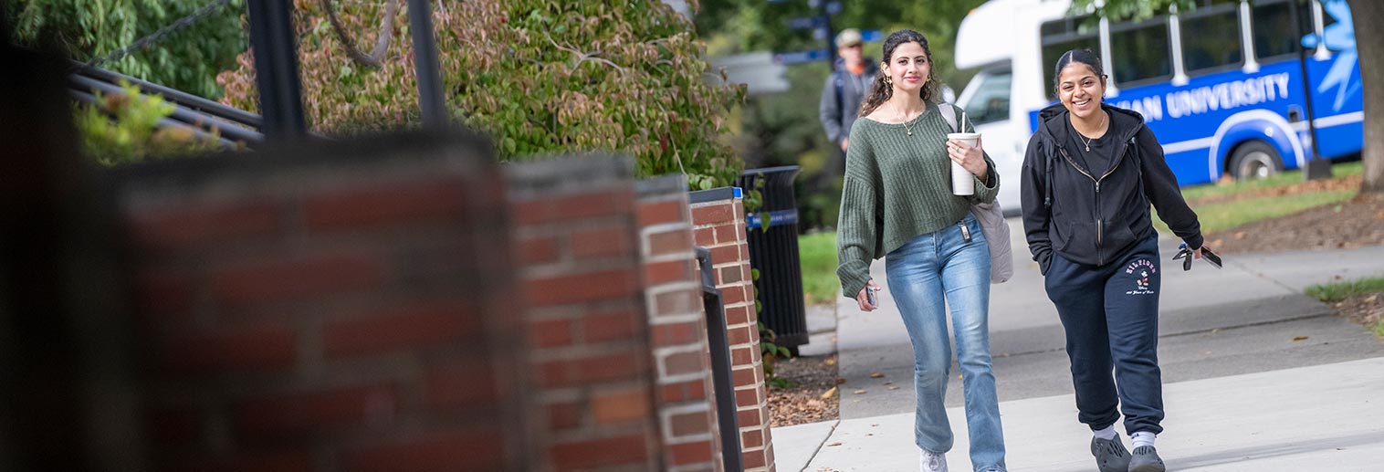 Two students walking outside Collier