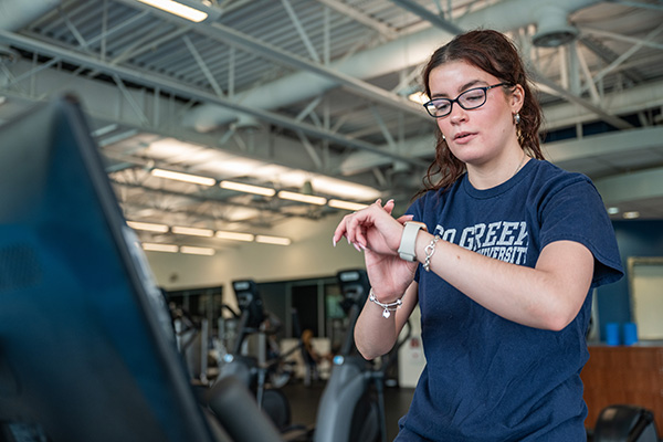 Student using Apple Watch in gym