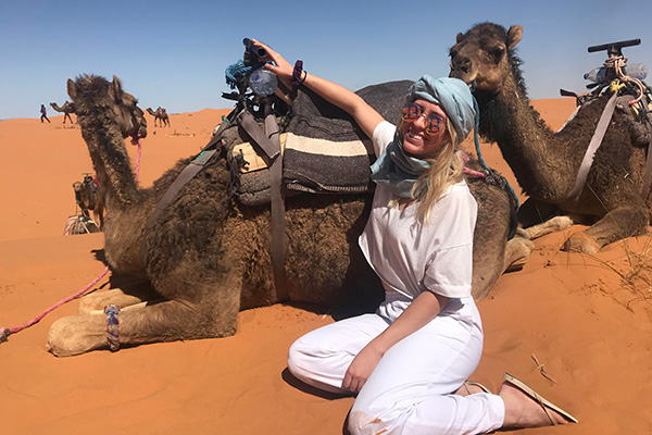 Student sitting with camel