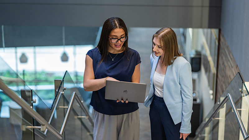 two women chatting on staricase