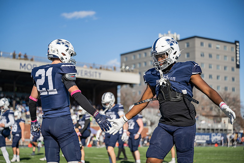 Football players high-fiving